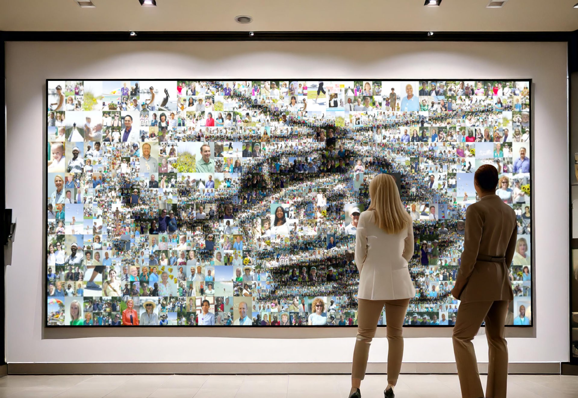 A large photo mosaic mural with created with Picture Mosaics software. Two people admiring the mosaic mural.